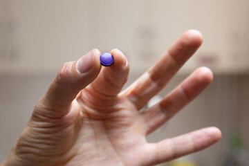 The nurse holds the plaque indication tablets in a pinch