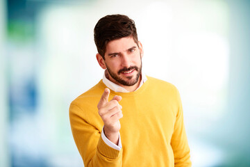 Handsom man wearing casual clothes and points his finger