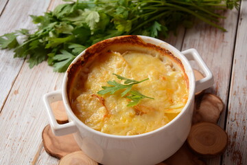 Potato gratin in baking white cocotte