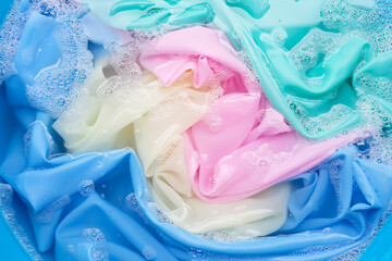 Color clothes soak in powder detergent water dissolution. Laundry concept