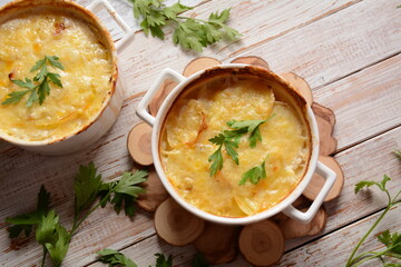 Potato gratin in baking white cocotte