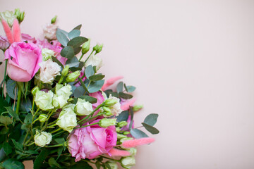 Delicate touching bouquet of white and pink flowers on a light pink background. Layout