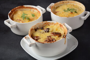 Potato gratin with mushrooms in baking cocottes