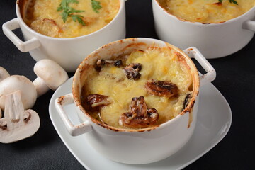 Potato gratin with mushrooms in baking cocottes