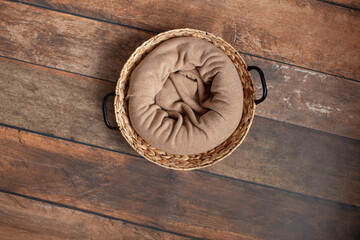Digital backdrop for newborn photo shoot. Wicker basket on wooden background. 