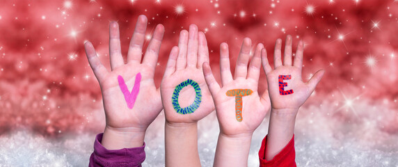 Children Hands Building Colorful English Word Vote. Red Snowy Christmas Winter Background With...