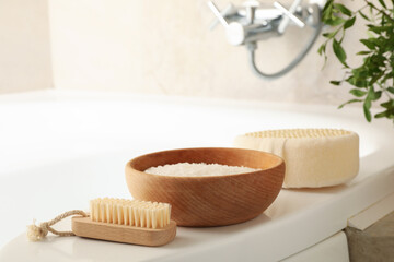 Bath with personal hygiene accessories in light beige bathroom