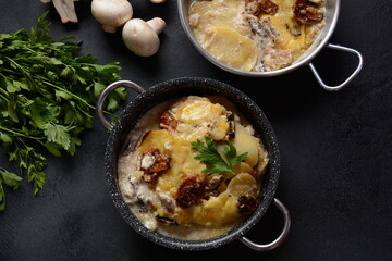 Potato gratin with mushrooms in casserole pan