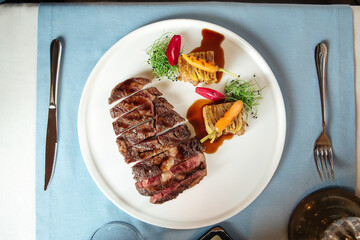 Cut grilled beef ribeye steak with potatoes