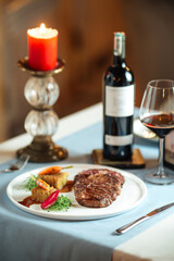 Grilled ribeye steak with potatoes with red wine