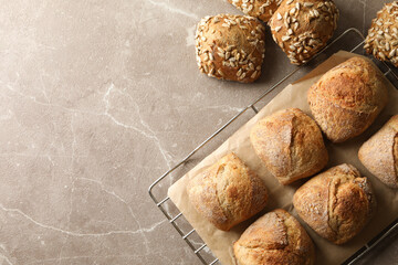 Cooling rack with fresh baked buns on gray background