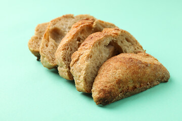 Sliced bun on mint background, close up