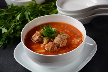 Patatesli Sulu Kofte - Turkish soup with meatballs in white bowl.