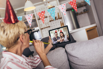 Senior woman having a birthday party on a video call