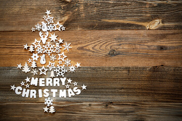White Little Christmas Decoration Items Building Christmas Tree Including Word Merry Christmas. Rustic Brown Wooden Background With Copy Space