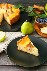 Plate with tasty pear cake on table