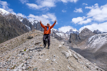 A man and dog at the level of glaciers. Very happy with the beautiful nature and mountains around him