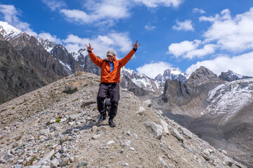 A man and dog at the level of glaciers. Very happy with the beautiful nature and mountains around him