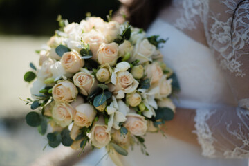 bride holding a bouquet of roses, bridal bouquet of white roses, wedding day