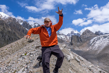 A man and dog at the level of glaciers. Very happy with the beautiful nature and mountains around him