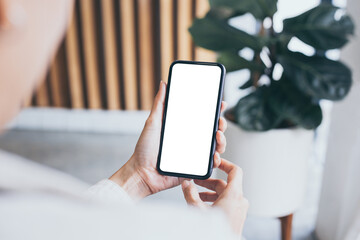 cell phone mockup blank white screen.woman hand holding texting using mobile on desk at coffee shop.background empty space for advertise.work people contact marketing business,technology