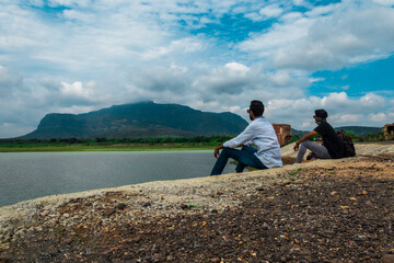 Fototapeta premium two young man sitting at pavaghad hill station, gujarat, india.
