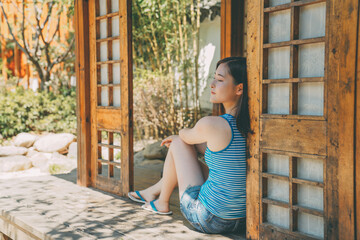 Fototapeta premium Summer watermelon and sweet girl in Japanese Garden