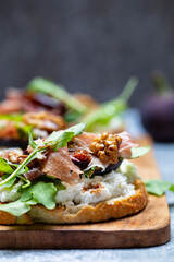 Canapes with ricotta cheese, figs, walnuts and parma ham
