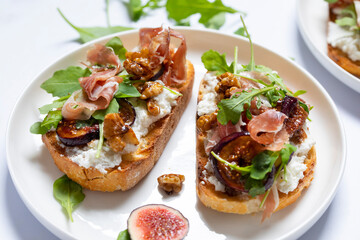 Canapes with ricotta cheese, figs, walnuts and parma ham