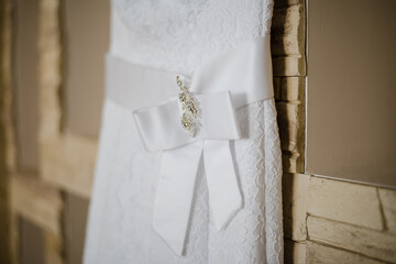 wedding dress on a hanger, gathering the bride