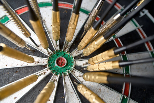 Many darts missed the center of the dartboard