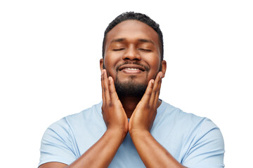 grooming, skin care and people concept - happy smiling african american touching his beard over...