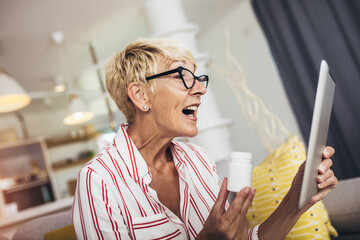 Senior woman using video conference, make online consultation with pharmacy consulting about...