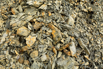 Grey and brown stone pile. Cracked mudstone siltstone and shale.