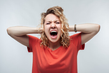 Image of stressed blonde girl grabbing her head. Problems, surprise, fear, fobia concept. Studio shot, white background