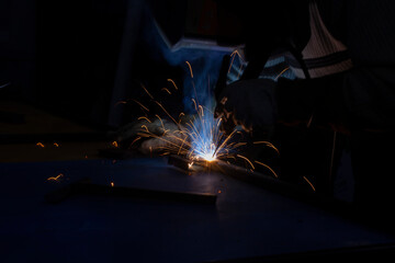 Sparks from metal welding. Welder to work. High temperature when working with a welding machine.