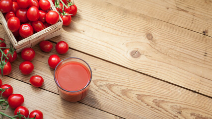 Many red cherry tomatoes on wooden table