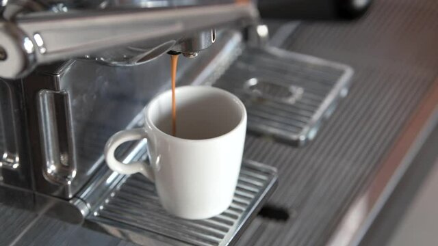 4K close-up video Making of a long espresso coffee drink on a special espresso machine.