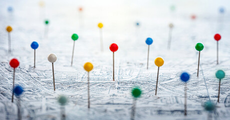 Multi-colored pins on the city map as a search symbol. Find your way among the many. Concept on the topic of geography, navigation, transport. Shallow depth of focus. Pins on map.