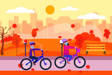 Autumn in new normal: Teenagers ride bicycle together in the park while doing health protocol