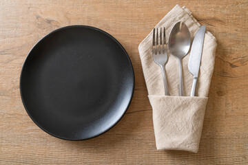 empty plate or dish with knife, fork and spoon