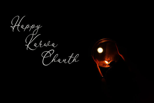Happy Karwa chauth greeting wish poster card with moon glowing diya on black background