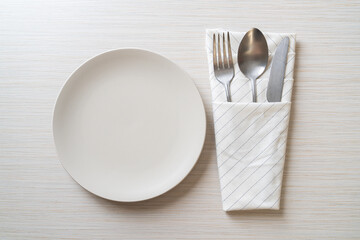 empty plate or dish with knife, fork and spoon