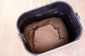 fresh loaf of black bread baked in an electric bread maker. Homemade baking.