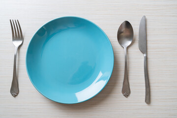 empty plate or dish with knife, fork and spoon