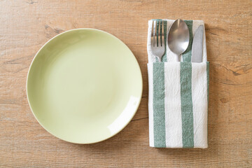empty plate or dish with knife, fork and spoon