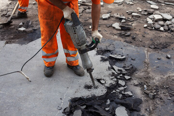 Working with a jackhammer. Removal of asphalt. Change of road surface.