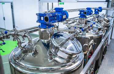 Interior of dairy factory with fermentation tank. Technology equipment at dairy farm. Sterile...