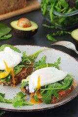 Homemade sandwiches with salmon, avocado and poached eggs