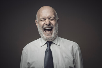 Fototapeta premium Cheerful businessman laughing out loud